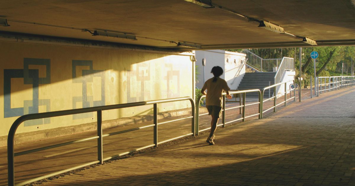 Running For Mental Clarity. Solitary runner finding mental clarity through early morning solitude.